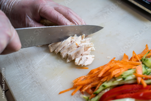 Chef cuts the vegetables into a meal. Preparing dishes. A man uses a knife and cooks.