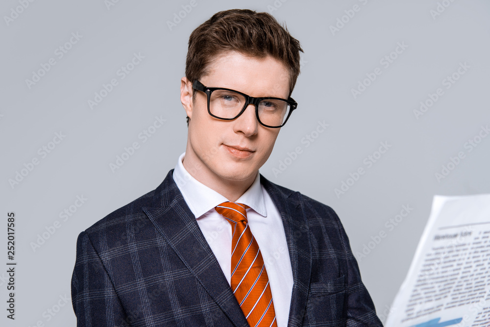 stylish handsome businessman with newspaper isolated on grey stylish handsome businessman with newspaper isolated on grey