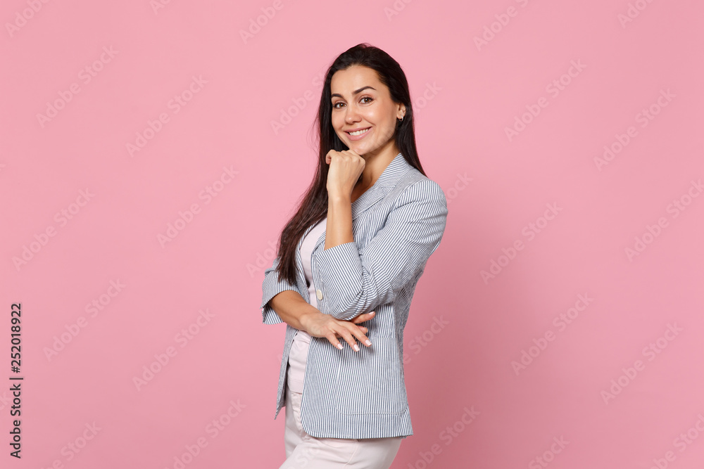Portrait of smiling young woman in striped jacket looking camera and put hand prop up on chin isolated on pink pastel wall background. People sincere emotions, lifestyle concept. Mock up copy space. Portrait of smiling young woman in striped jacket looking camera and put hand prop up on chin isolated on pink pastel wall background. People sincere emotions, lifestyle concept. Mock up copy space.
