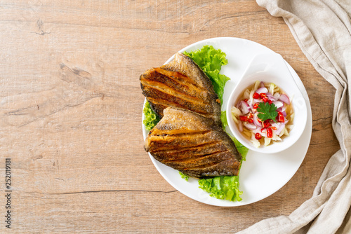 crispy gourami fish with spicy salad photo