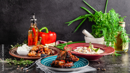 The concept of American cuisine. American dishes on the table. Meat, soup, glazed chicken wings. Background image. copy space