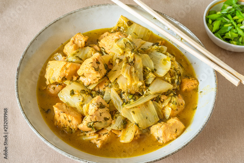 Chicken with cabbage and curry sauce in a large bowl and chopsticks - Thai cuisine