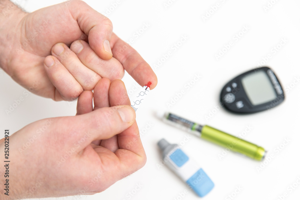 Diabetic is doing a glucose level finger blood test Diabetic is doing a glucose level finger blood test