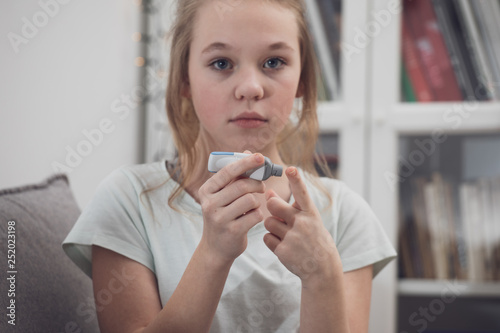 Fototapeta Naklejka Na Ścianę i Meble -   diabetic girl checking blood sugar level