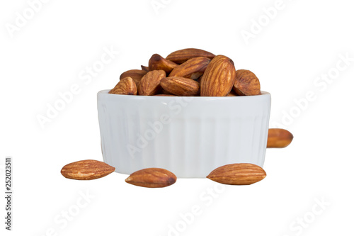 Almonds in white porcelain bowl isolated on white background