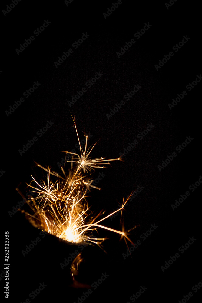 сlose-up of fire flame with sparks from the gas pocket lighter in different shapes isolated on a black background.  concept of stopping and freezing the moment.