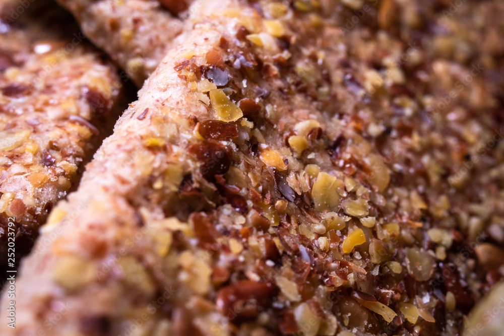 Integral crackers with healthy seeds: linseeds, chia, cracked pumpkin seeds, sunflower, sesame and spices with whole wheat flour. Macro photography Integral crackers with healthy seeds: linseeds, chia, cracked pumpkin seeds, sunflower, sesame and spices with whole wheat flour. Macro photography