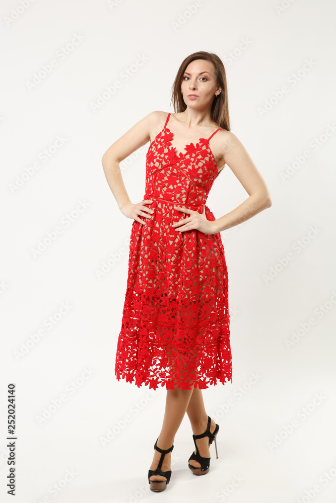 Full length photo of fashion model woman wearing elegant evening dress gown posing isolated on white wall background studio portrait. Brunette long hair girl. Mock up copy space. Red dress face view. Full length photo of fashion model woman wearing elegant evening dress gown posing isolated on white wall background studio portrait. Brunette long hair girl. Mock up copy space. Red dress face view.