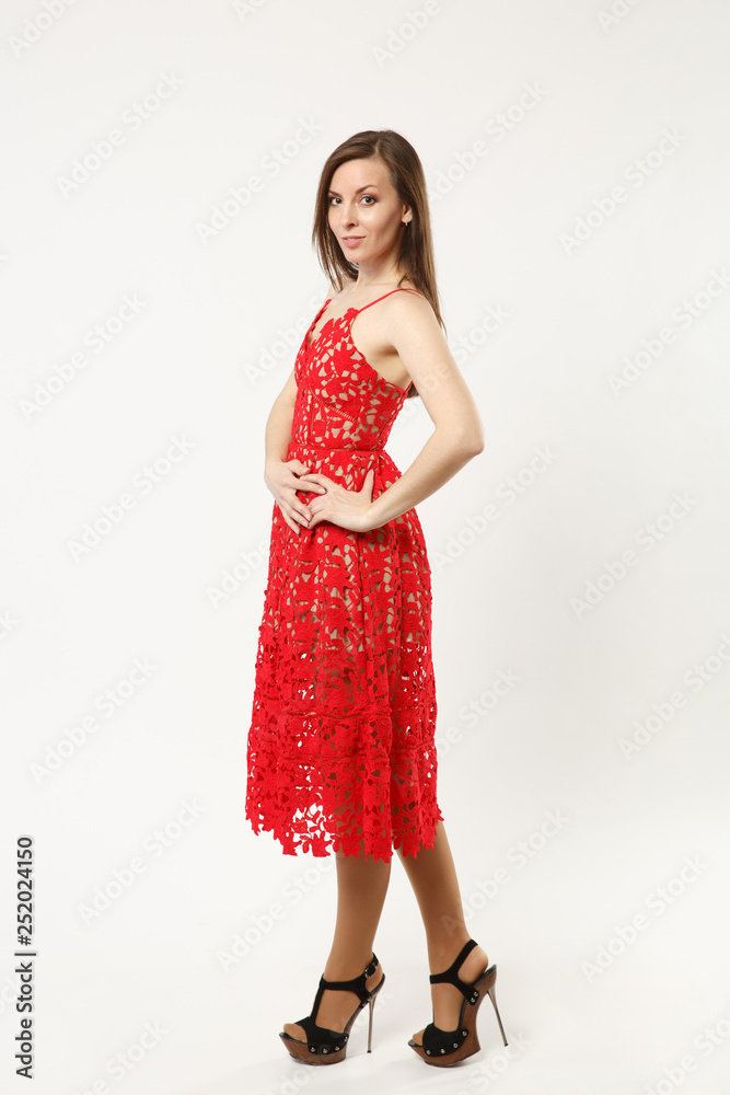 Full length photo fashion model woman wearing elegant evening dress red gown posing isolated on white wall background studio portrait. Brunette long hair girl. Mock up copy space. Side profile view. Full length photo fashion model woman wearing elegant evening dress red gown posing isolated on white wall background studio portrait. Brunette long hair girl. Mock up copy space. Side profile view.