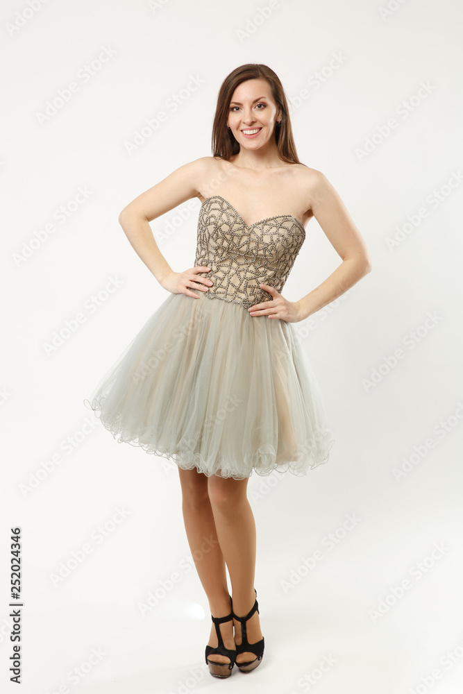 Full length photo of fashion model woman wearing elegant evening dress gown posing isolated on white wall background studio portrait. Brunette long hair girl. Mock up copy space Pastel dress face view