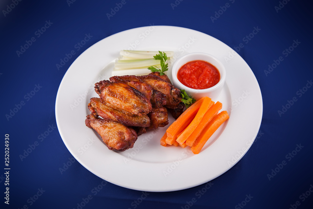 Roasted chicken wings with carrots, celery and dipping sauce