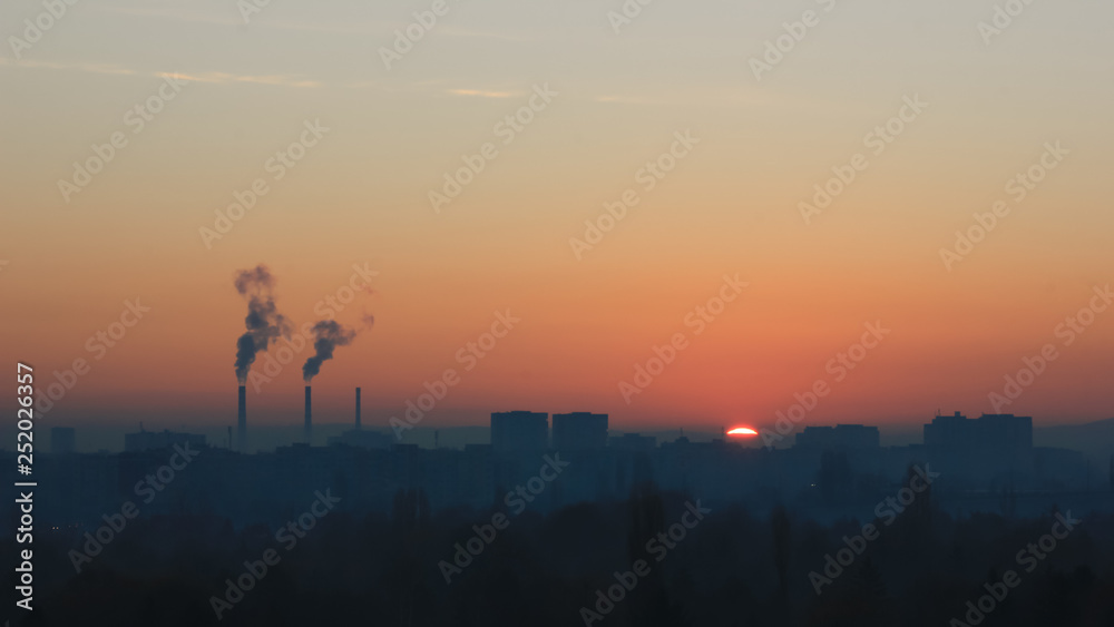 Factory smoke at sunset sky