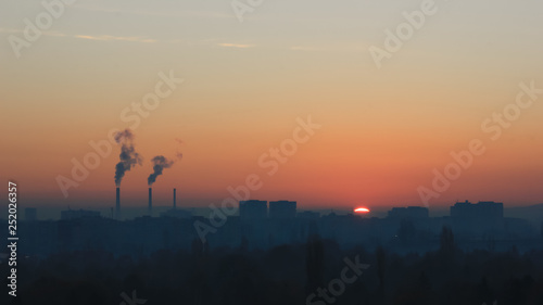 Factory smoke at sunset sky