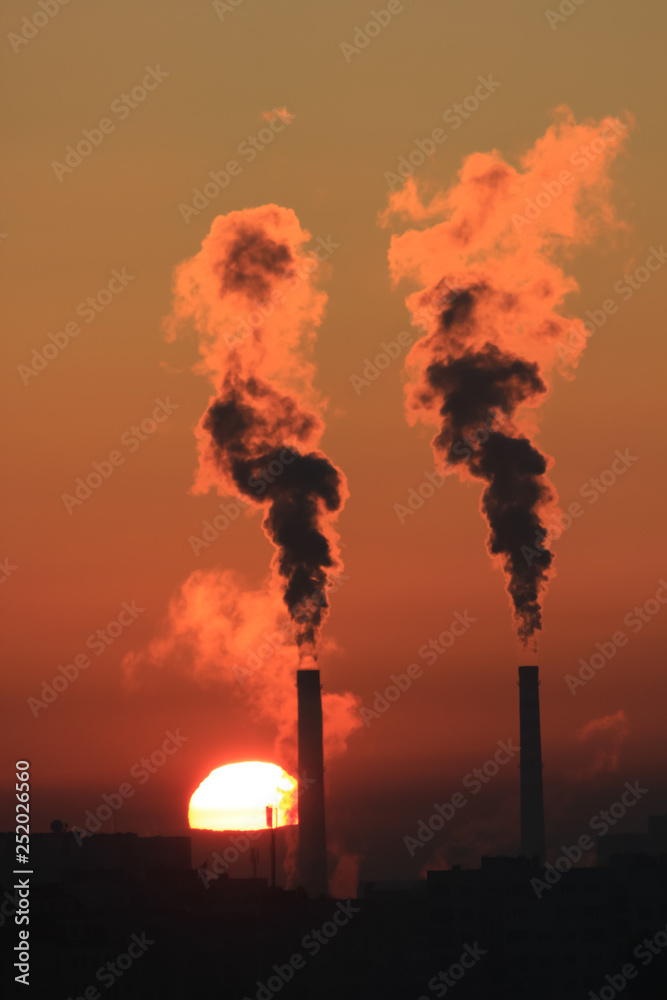 Fototapeta premium Factory smoke at sunset sky