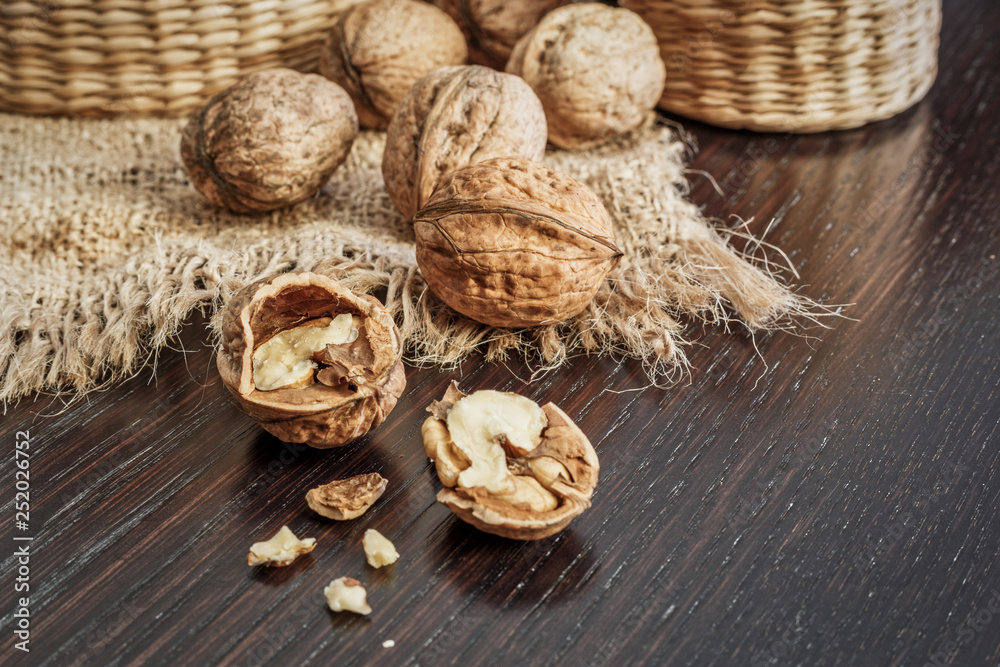 Walnuts on a dark wooden table with rustic background Walnuts on a dark wooden table with rustic background