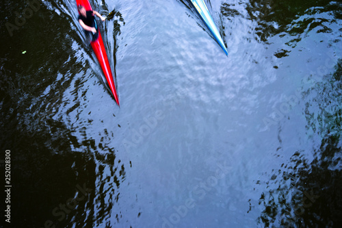 Two kayaks on the water with reflection