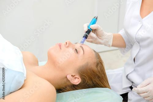 Cosmetologist making mesotherapy injection. Microneedle mesotherapy. Treatment woman at beautician. Hardware cosmetology. Mesotherapy  dermapen  treatment of face zone  face rejuvenation.  Close up