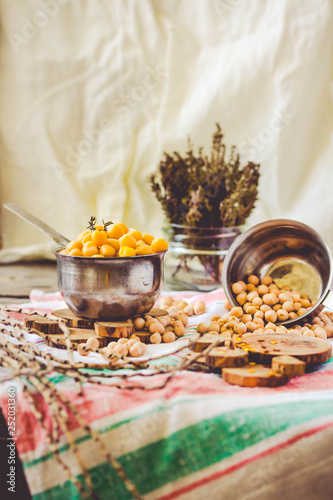 Dried and boiled chickpeas. Vegetarian protein. Dry thyme sprigs in a jar. Healthy lifestyle and balanced food concept. Selective focus.Toning.