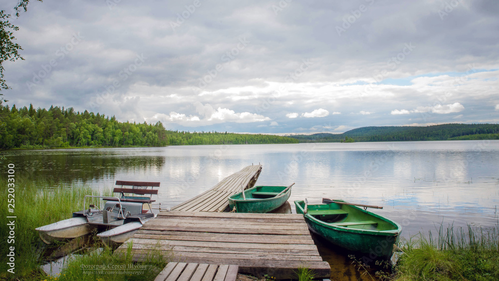 pier with boats on the lake