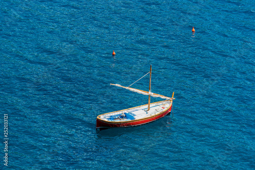 Small wooden boat with sail in the sea - Italy © Alberto Masnovo