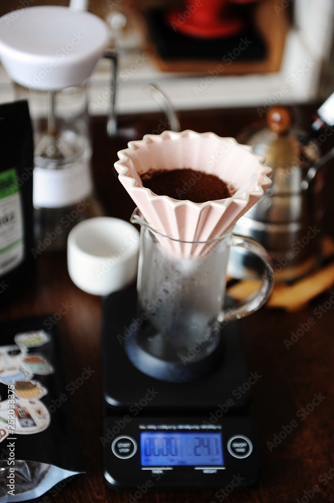 Alternative coffee brewing. Pink ceramic origami dripper. Coffee grinder. Gooseneck kettle. Electronic scale