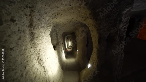 Derinkuyu underground city caves in Cappadocia. Walking through ancient carved rock dwellings deep in the ground in Turkey. Long claustrophobic narrow passages.