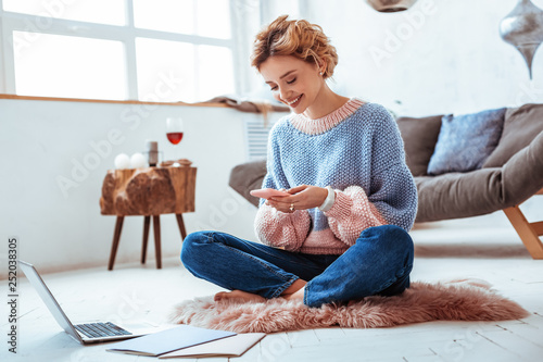 Beautiful nice happy woman typing a message photo