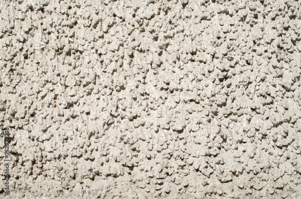 Old grey plaster on wall closeup