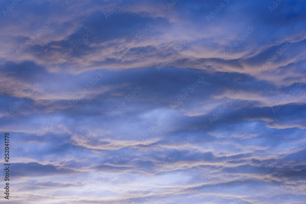 Beautiful wavy cloudy sky at sunset, natural background