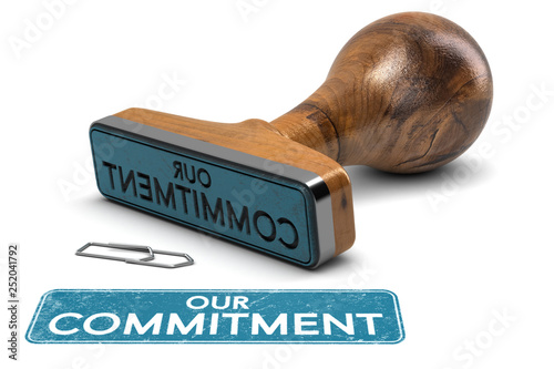 Our Commitment, Rubber Stamp Text Over White Background photo