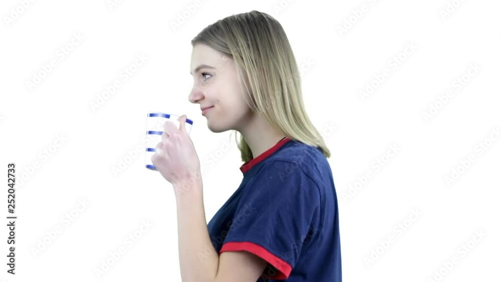 Happy girl drinking coffee and relaxing , isolated on white background.Smiling and looking at camera. Happy girl drinking coffee and relaxing , isolated on white background.Smiling and looking at camera.