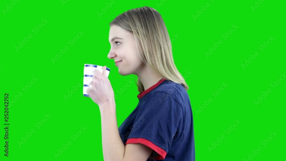Smiling girl holding coffee cup. Isolated on green background. Chroma key Smiling girl holding coffee cup. Isolated on green background. Chroma key
