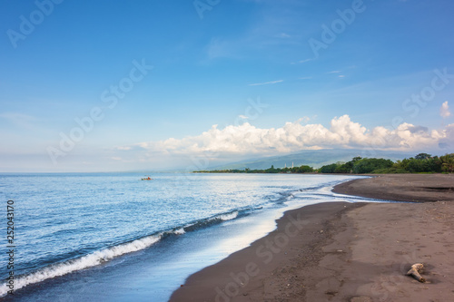 a dark sand beach in northern Bali Indonesia