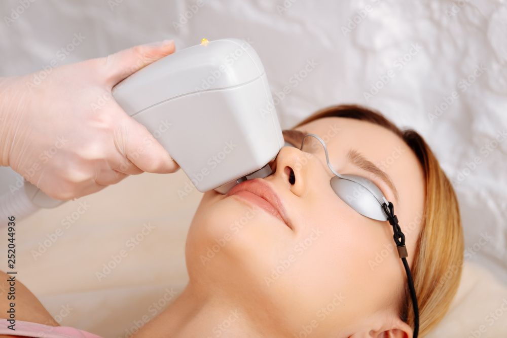 Naklejka premium Woman visiting good depilatory salon for face depilation
