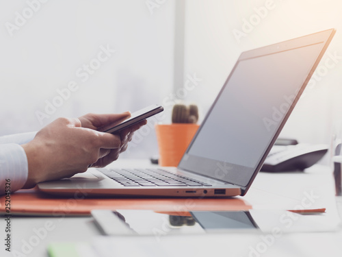 Corporate businesswoman working and connecting with her smartphone