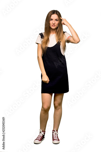 Full body Young pretty woman making the gesture of madness putting finger on the head on isolated background