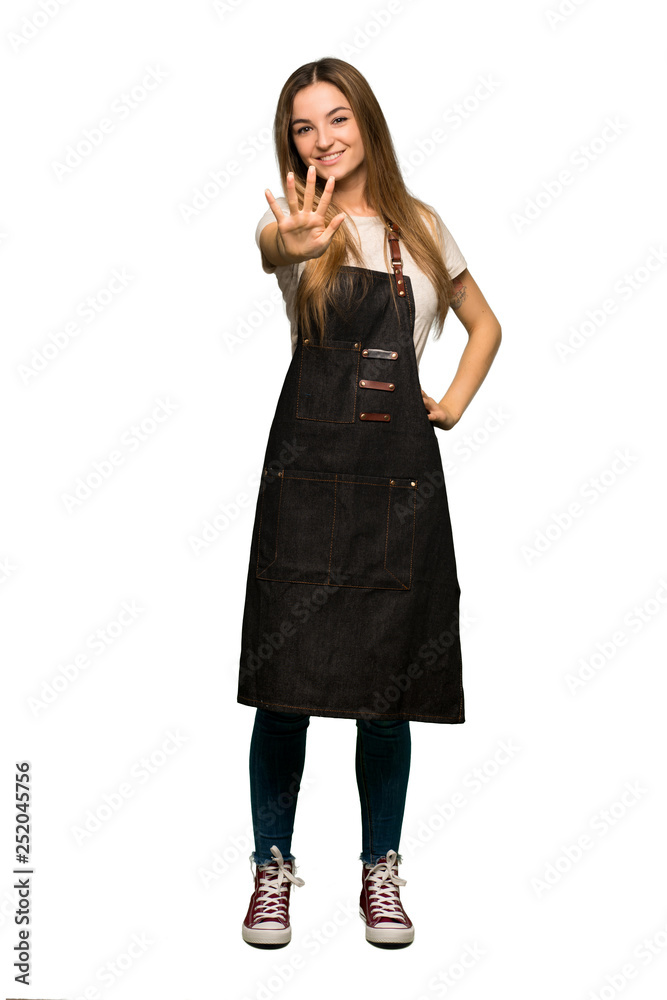 Full body Young woman with apron counting five with fingers on isolated background