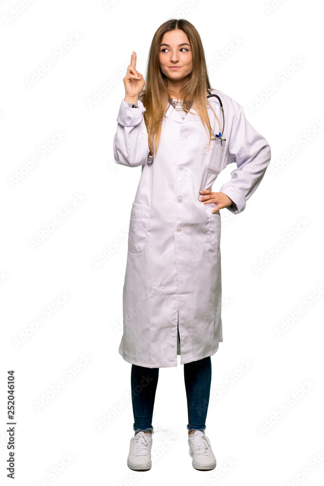 Full body Young doctor woman with fingers crossing and wishing the best on isolated background Full body Young doctor woman with fingers crossing and wishing the best on isolated background