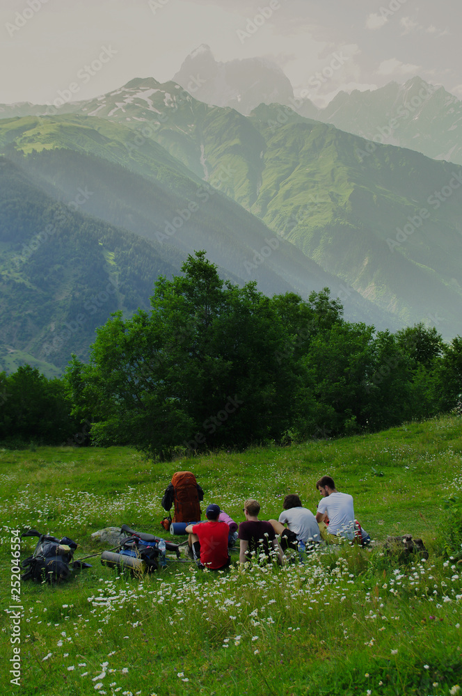 Friends resting while hiking in the caucasus mountains