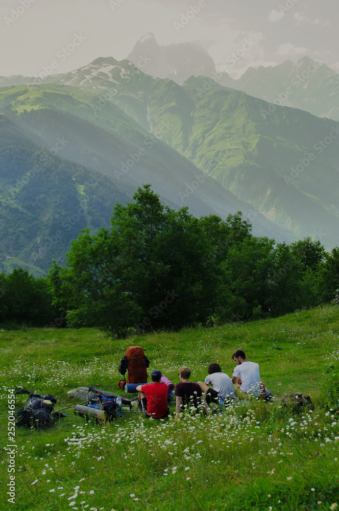 Fototapeta premium Friends resting while hiking in the caucasus mountains