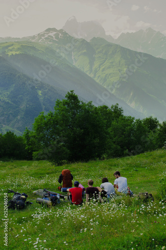 Friends resting while hiking in the caucasus mountains