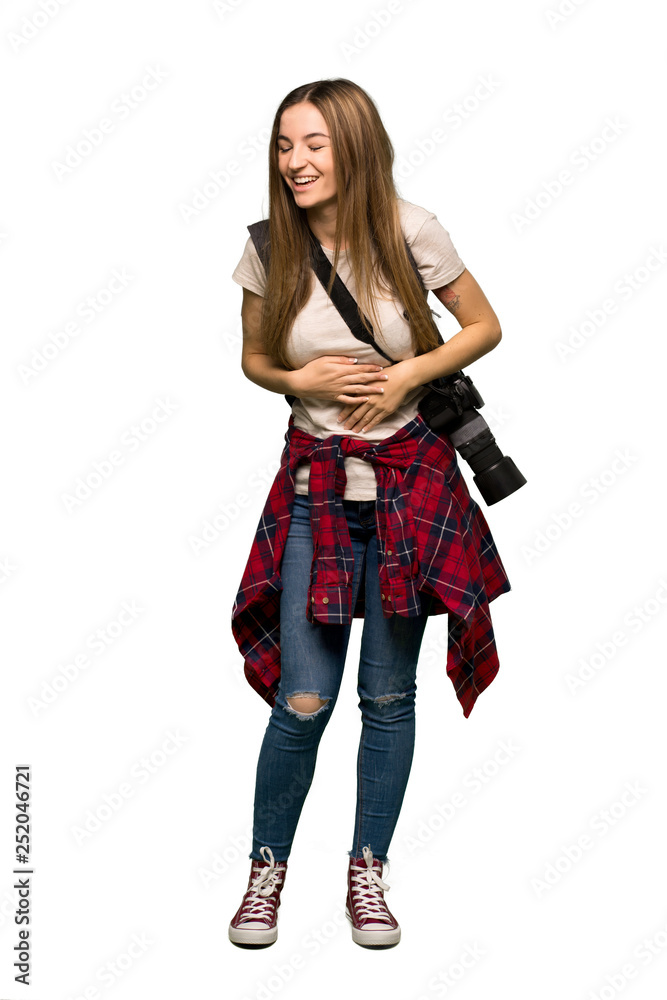 Full body Young photographer woman smiling a lot while putting hands on chest on isolated background