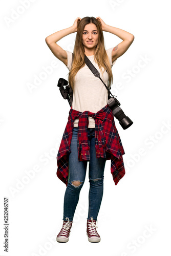 Full body Young photographer woman takes hands on head because has migraine on isolated background