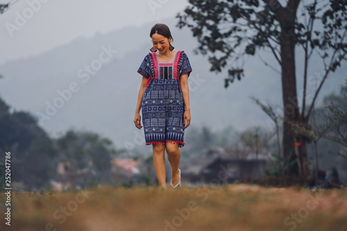 portrait of beautiful asian woman in dress north in lanna thai style with walking in nature in smile and relaxing emotional © etemwanich