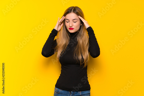 Young pretty woman over yellow background unhappy and frustrated with something © luismolinero