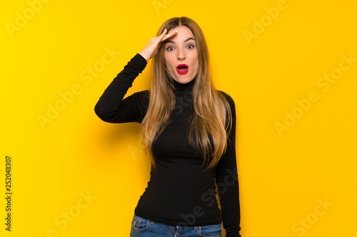 Young pretty woman over yellow background has just realized something and has intending the solution
