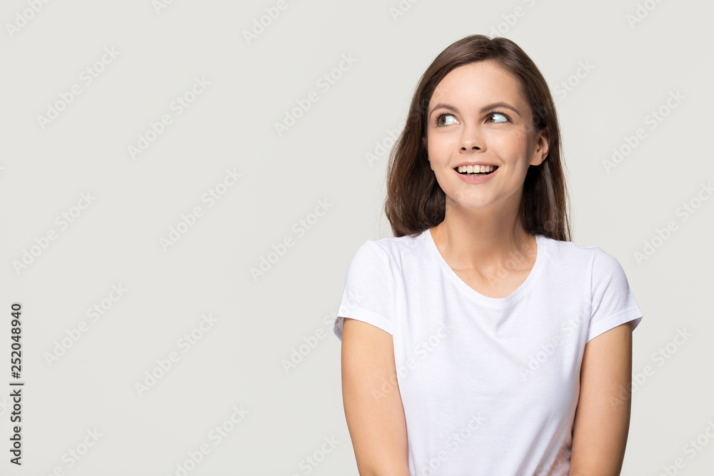 Happy teen girl looking at copy space isolated on background Happy teen girl looking at copy space isolated on background