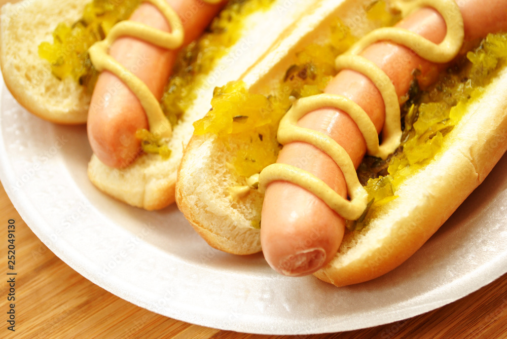 Hot Dogs with Relish and Mustard On a White Plate