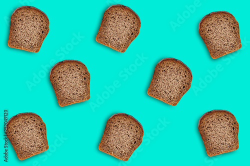 Chaotic scattered many rectangular pieces of fresh rye bread on green table on kitchen. Seamless pattern. Top view. Dieting concept