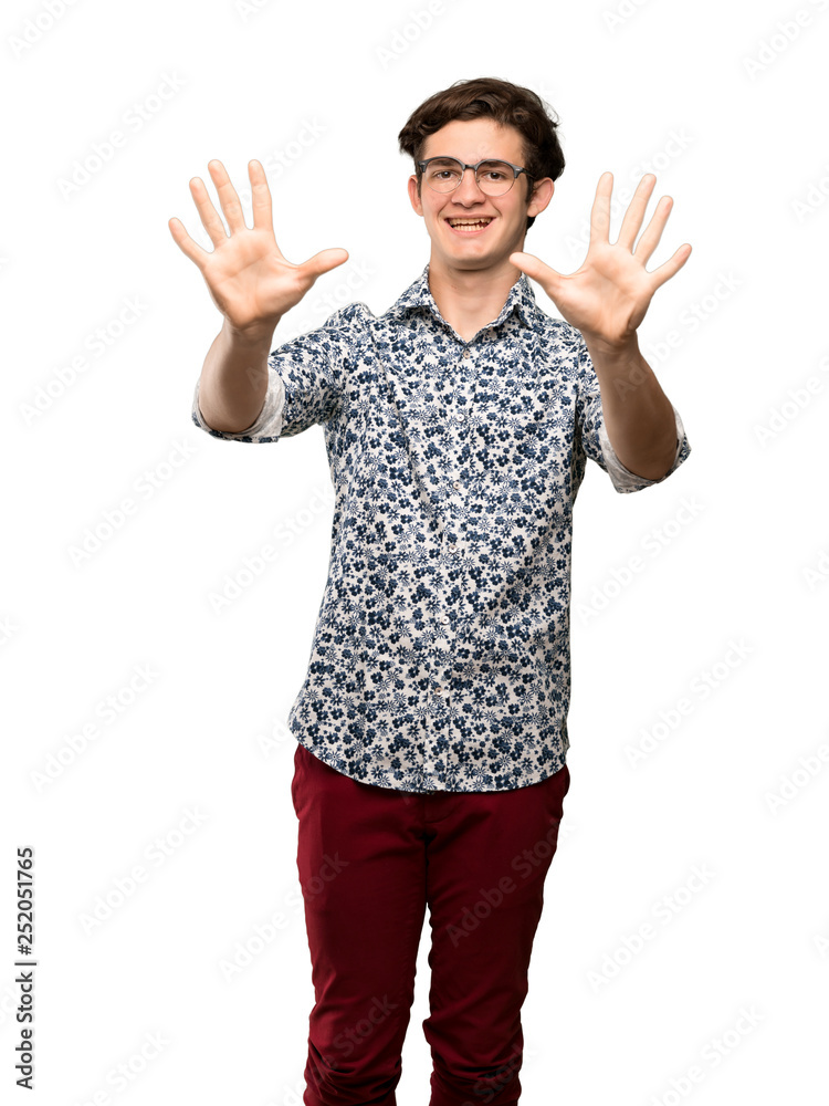 Teenager man with flower shirt and glasses counting ten with fingers over isolated white background Teenager man with flower shirt and glasses counting ten with fingers over isolated white background